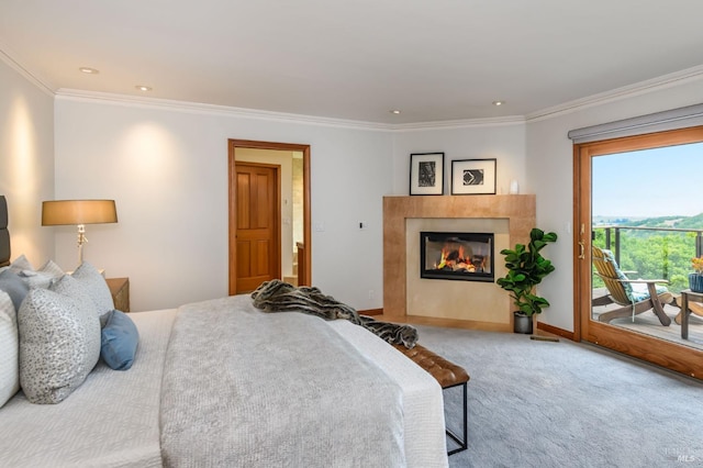 bedroom featuring a glass covered fireplace, crown molding, carpet, and access to exterior