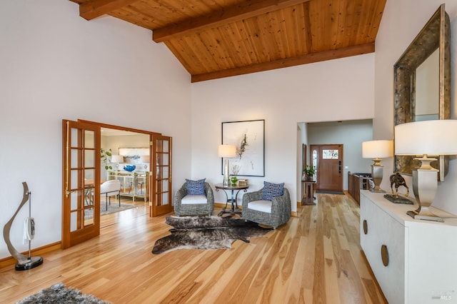 living area with french doors, light wood finished floors, high vaulted ceiling, and wooden ceiling