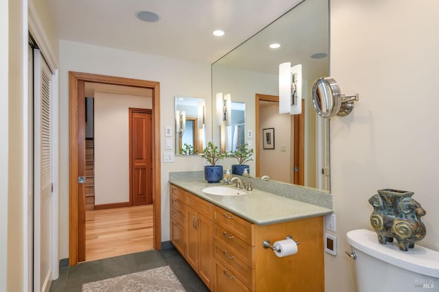 bathroom with vanity, recessed lighting, tile patterned flooring, and toilet
