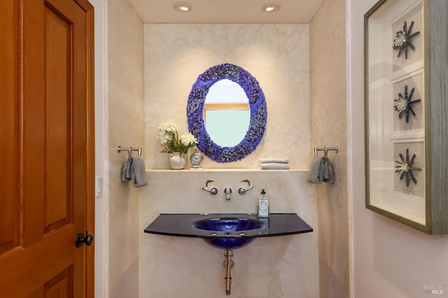 bathroom with a sink and recessed lighting