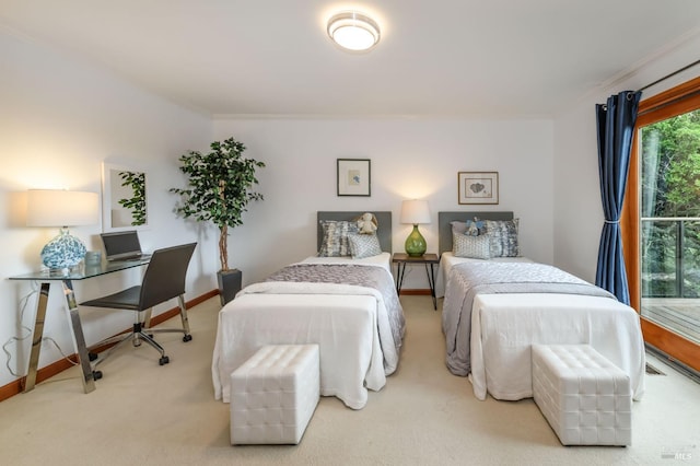 carpeted bedroom with crown molding and baseboards