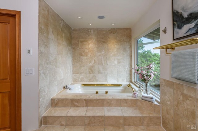 full bath with recessed lighting, a bath, and tile walls