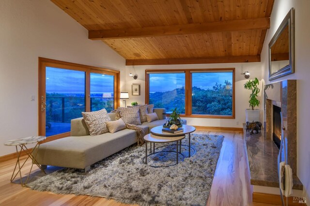 living room featuring wood ceiling, vaulted ceiling with beams, baseboards, and wood finished floors