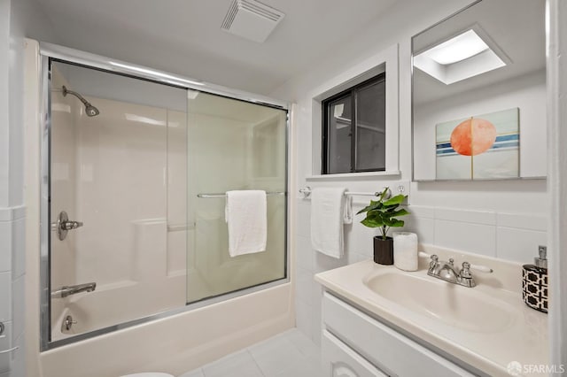 full bathroom featuring tile patterned floors, visible vents, vanity, and shower / bath combination with glass door
