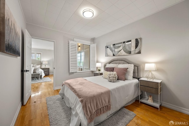 bedroom with baseboards and light wood-style floors