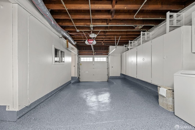 garage featuring washer / dryer and baseboards