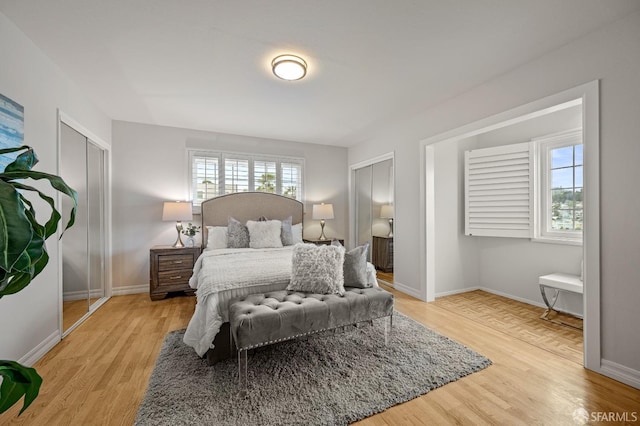 bedroom with light wood-style flooring and baseboards