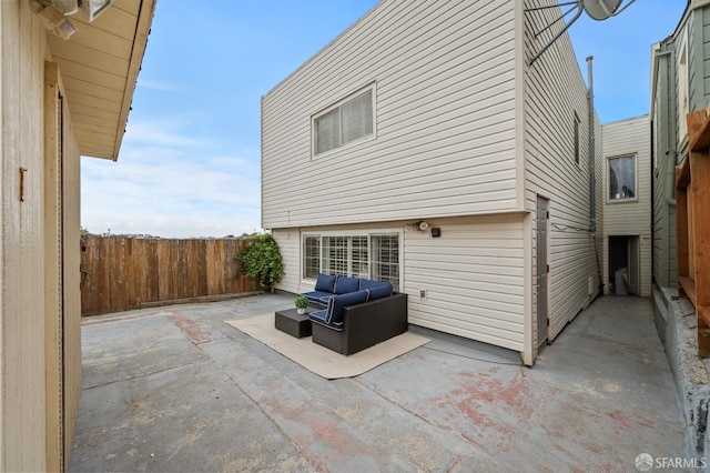 back of house with fence, outdoor lounge area, and a patio