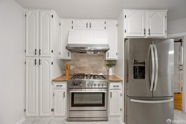 kitchen with white cabinetry, exhaust hood, backsplash, and appliances with stainless steel finishes