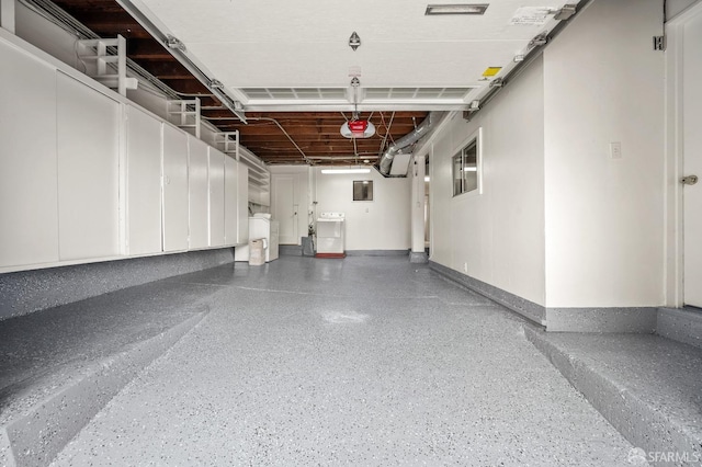 garage with washer / dryer, a garage door opener, and electric panel