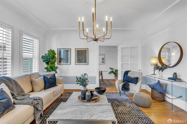 living room with light hardwood / wood-style flooring and a notable chandelier