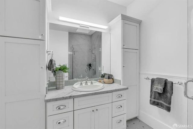 bathroom with tile patterned floors, a shower with door, and vanity