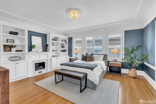 bedroom with a notable chandelier and light hardwood / wood-style flooring