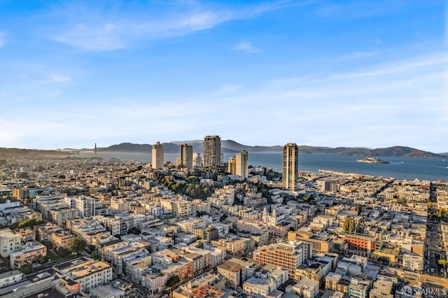 property's view of city featuring a water and mountain view