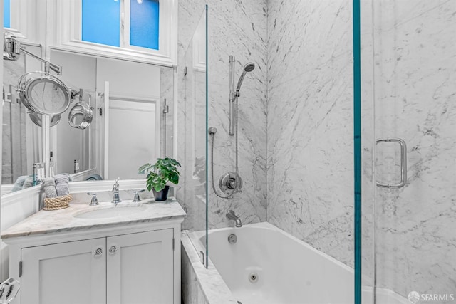 bathroom featuring vanity and bath / shower combo with glass door