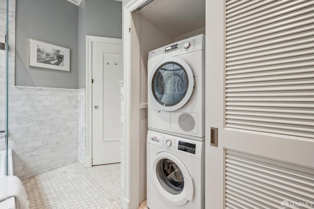 laundry area featuring laundry area and stacked washer / dryer