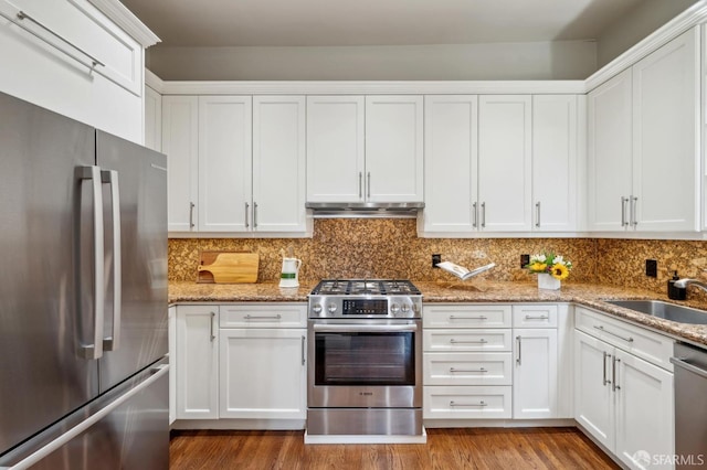 kitchen with a sink, appliances with stainless steel finishes, and white cabinets