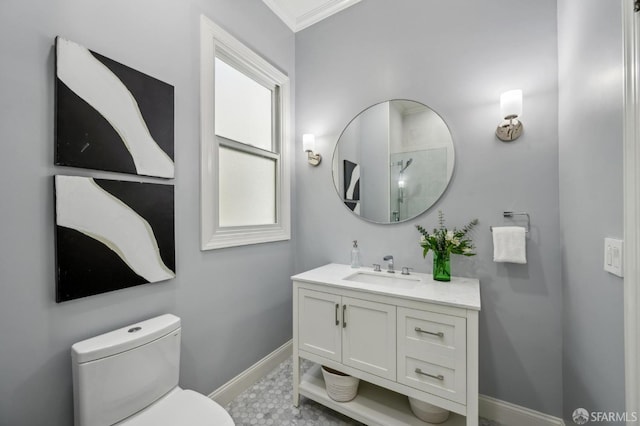 bathroom featuring baseboards, ornamental molding, toilet, and vanity