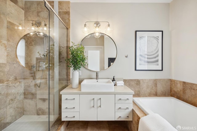 bathroom featuring shower with separate bathtub and vanity