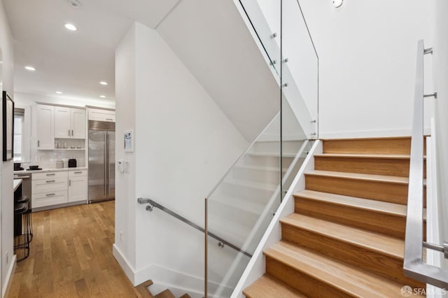 stairway featuring hardwood / wood-style flooring