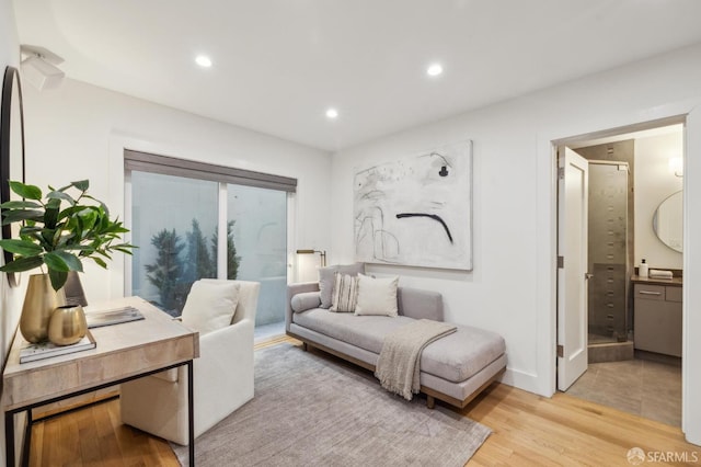 home office with light hardwood / wood-style flooring