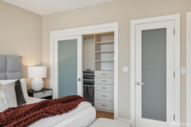 bedroom featuring wood-type flooring and a closet