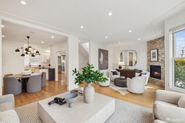 living room with a fireplace and light hardwood / wood-style flooring