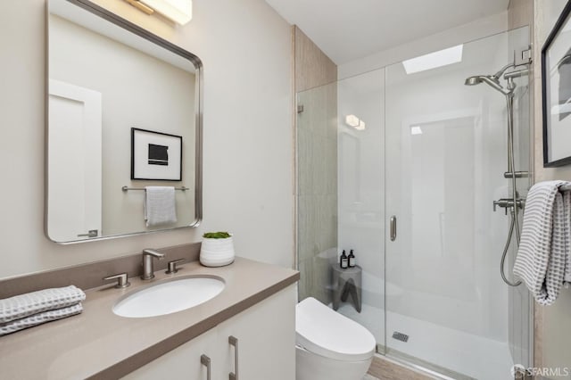 bathroom featuring vanity, an enclosed shower, and toilet