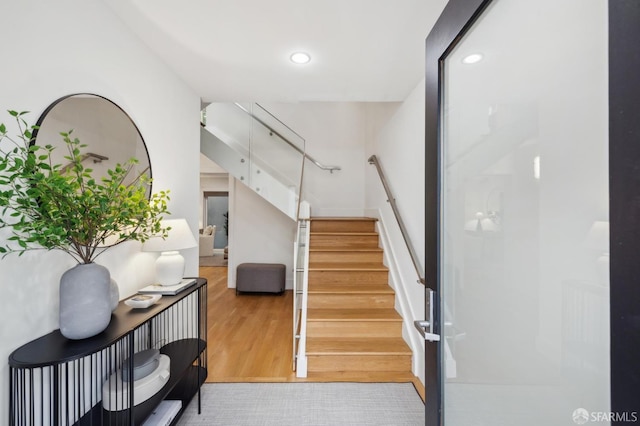 stairway with hardwood / wood-style flooring