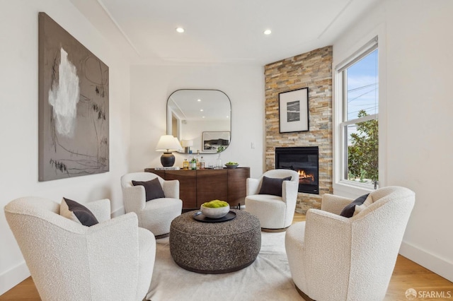 living room with a fireplace and light wood-type flooring