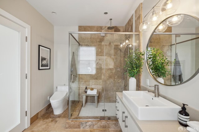 bathroom with walk in shower, vanity, and toilet