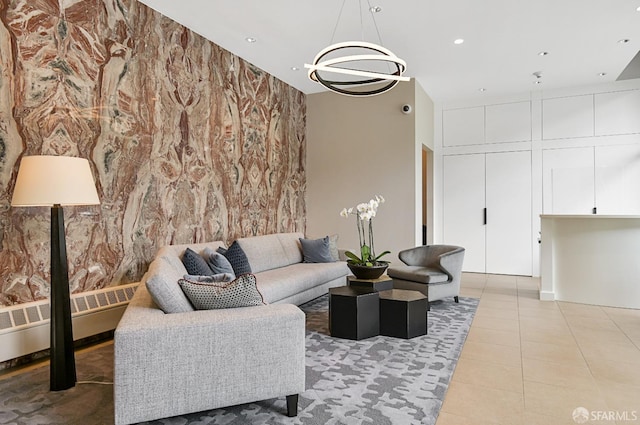 living room with radiator heating unit, light tile patterned floors, and an inviting chandelier