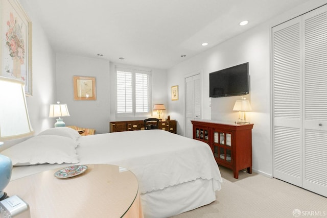 carpeted bedroom featuring two closets