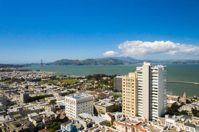 birds eye view of property with a water and mountain view