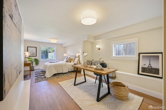 bedroom featuring wood finished floors and baseboards