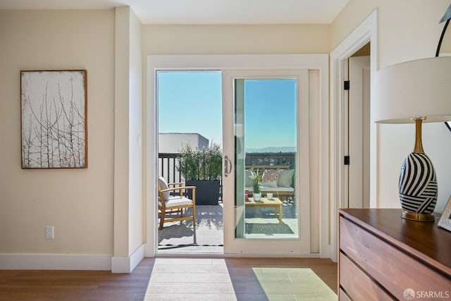 entryway with wood finished floors and baseboards