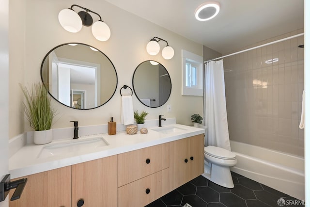 full bath featuring tile patterned flooring, a sink, toilet, and double vanity