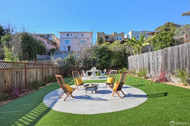 view of patio featuring a fenced backyard and a fire pit