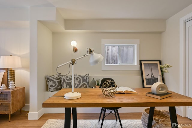 office with baseboards and light wood-style floors