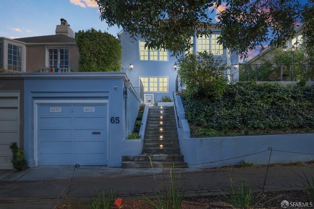 65 San Pablo Ave, San Francisco, CA 94127 - view of front of property featuring stucco siding, stairway, a chimney, a garage, and concrete driveway