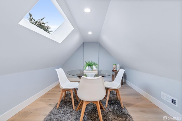 65 San Pablo Ave, San Francisco, CA 94127 - dining room with visible vents, baseboards, vaulted ceiling with skylight, and light wood-type flooring