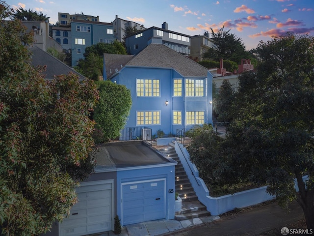 65 San Pablo Ave, San Francisco, CA 94127 - view of front facade featuring stairs, roof with shingles, stucco siding, and central AC