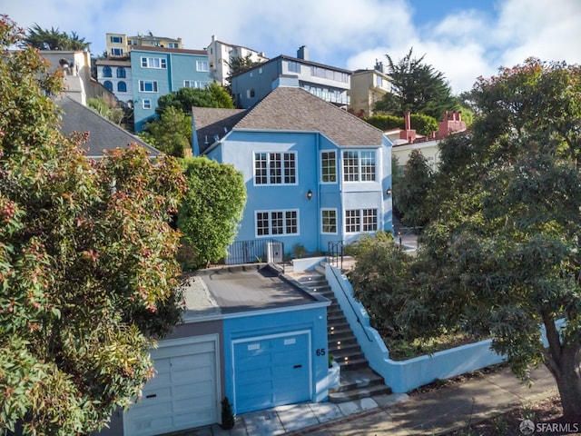 65 San Pablo Ave, San Francisco, CA 94127 - rear view of house with a garage, stairway, and stucco siding