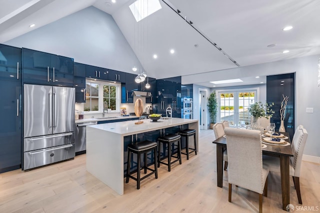 65 San Pablo Ave, San Francisco, CA 94127 - kitchen featuring a breakfast bar, a kitchen island with sink, a sink, light countertops, and stainless steel appliances