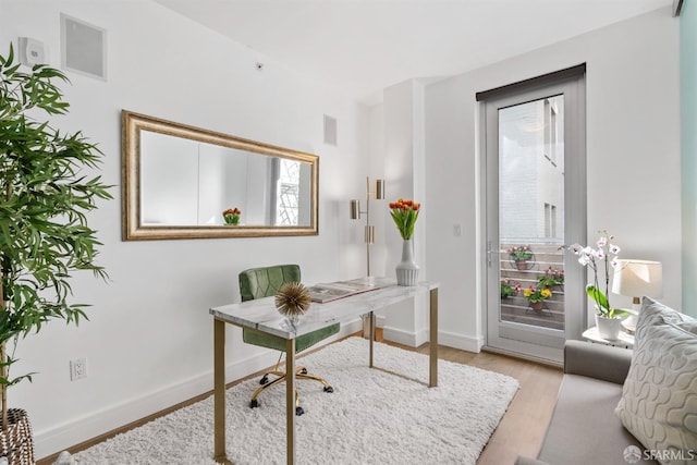 office featuring light wood-style flooring and baseboards