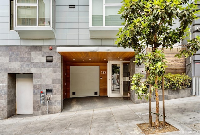 property entrance with driveway and elevator