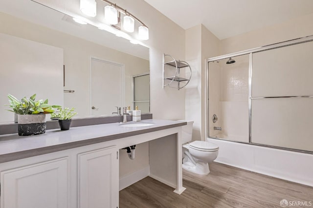 2225 23rd St Unit 318, San Francisco, CA 94107 - full bathroom featuring bath / shower combo with glass door, vanity, and wood finished floors