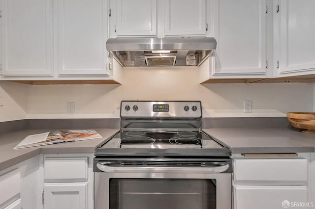 2225 23rd St Unit 318, San Francisco, CA 94107 - kitchen with range hood, stainless steel electric stove, and white cabinetry