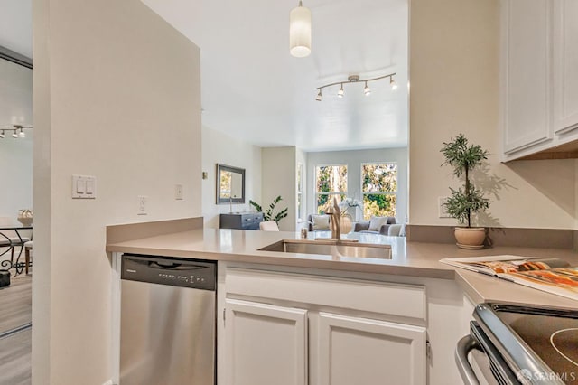 2225 23rd St Unit 318, San Francisco, CA 94107 - kitchen with appliances with stainless steel finishes, rail lighting, white cabinetry, a peninsula, and light countertops