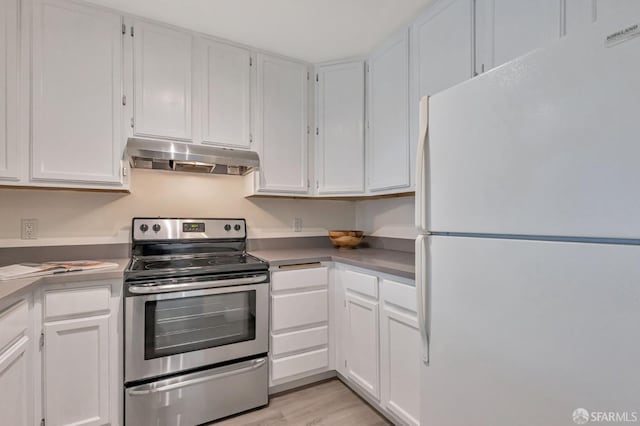 2225 23rd St Unit 318, San Francisco, CA 94107 - kitchen featuring freestanding refrigerator, electric stove, under cabinet range hood, and white cabinetry